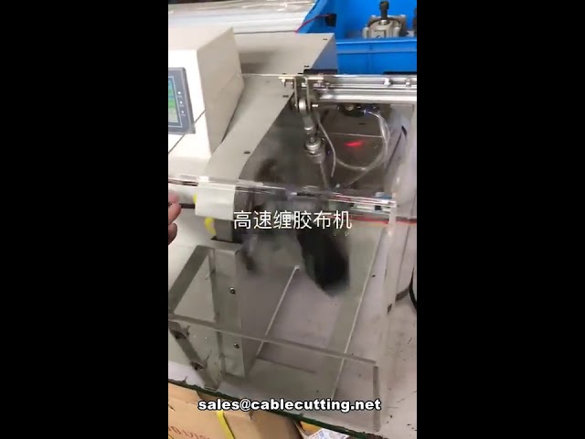 Machine automatique d'enrubannage et de bobinage pour câbles multibrins, avec capot de protection